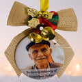 Memorial ornament with a photo of an elderly man and decorative elements on a white background.